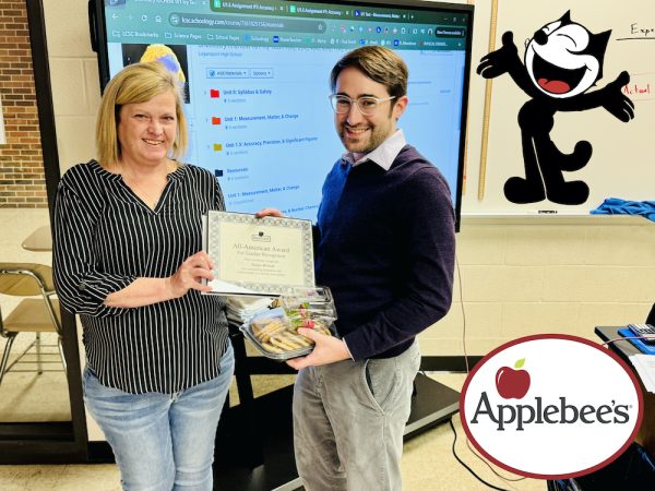 Teacher Mr. McCord smiles for the camera as he receives his Teacher of the Month Award.
