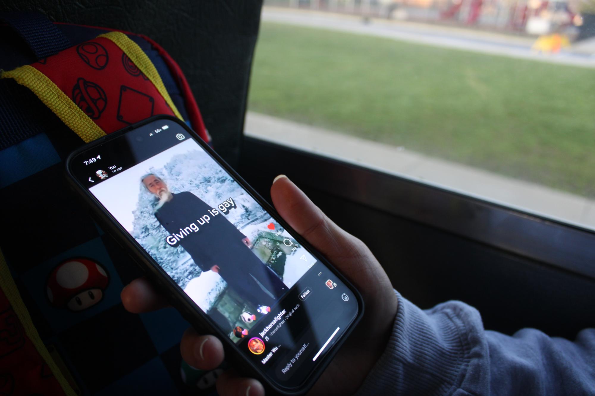 A student watching an Instagram reel captioned "giving up is gay."