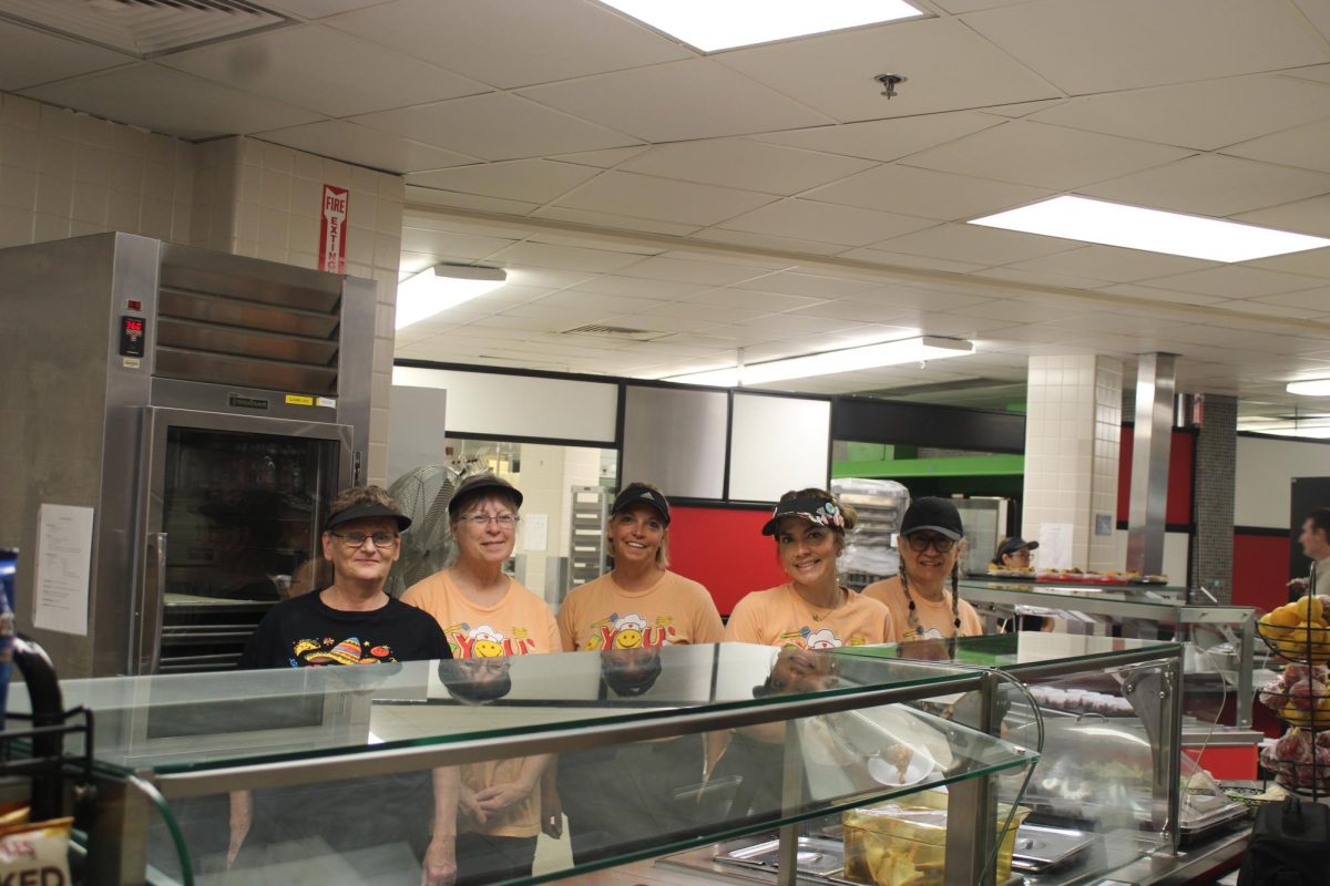 Food service workers prepare the High School cafeteria for the swarm of students at lunchtime.