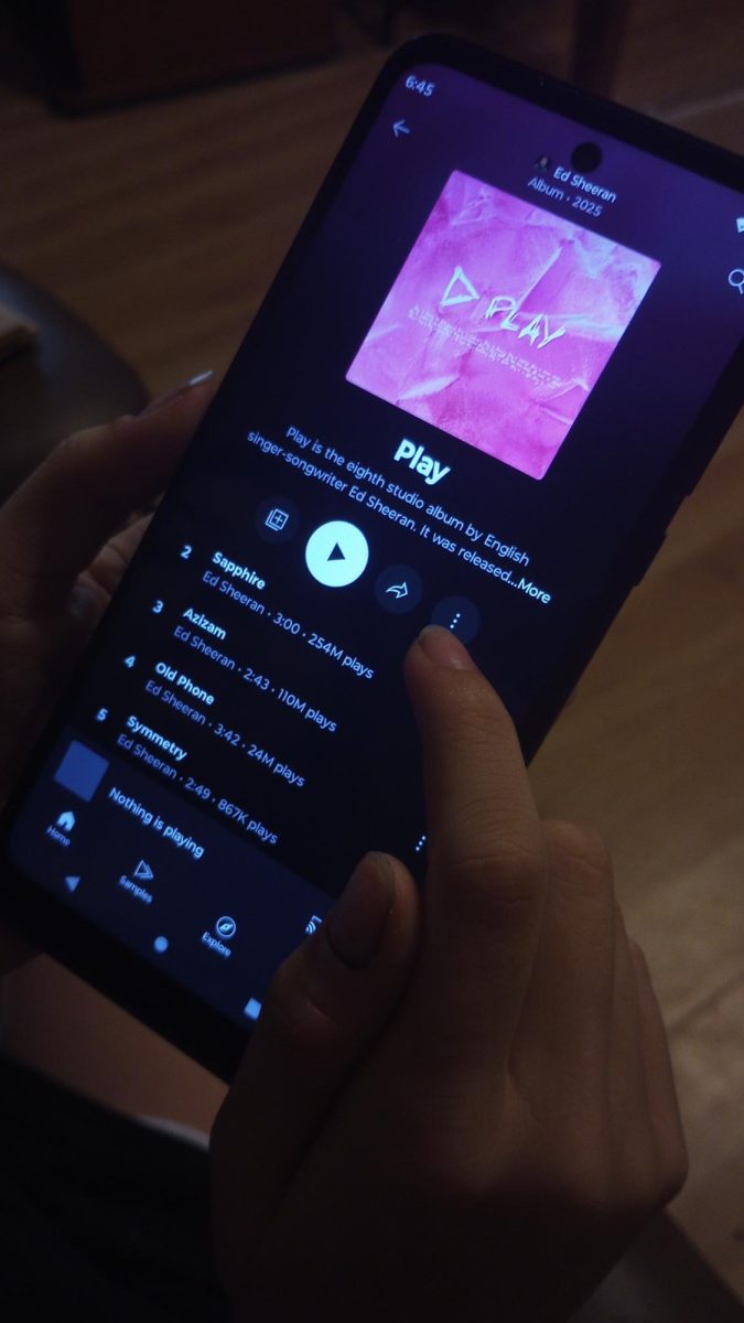 A student scrolls through Ed Sheeran's latest album, "Play".