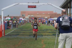 Senior Eric Garcia coming through the finish line with a time of 22:24. Eric alongside the rest of the boys team ran at the New Prairie Invite on Sept. 20.
