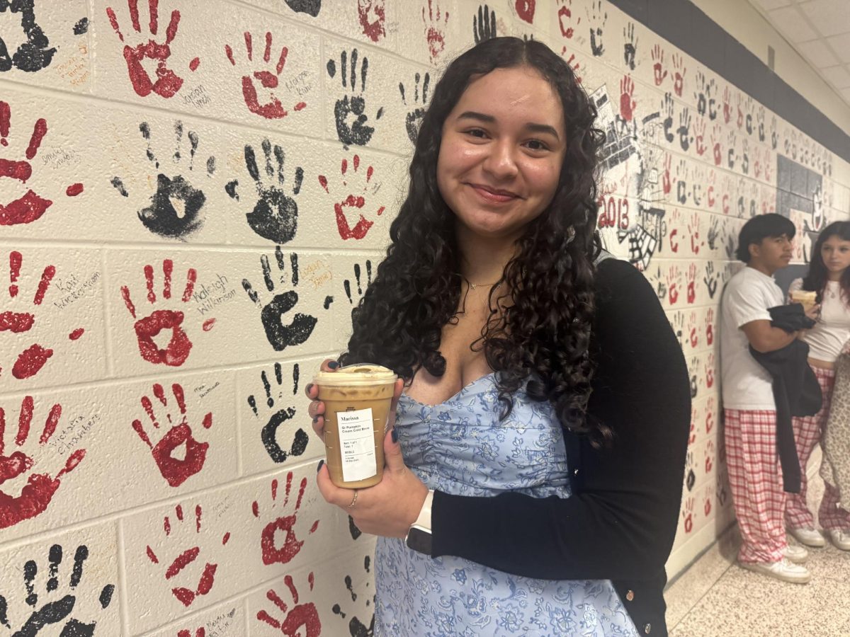 Julitza Gonzalez poses with the Pumpkin Cream Cold Brew, one of Starbucks' current fall beverages.