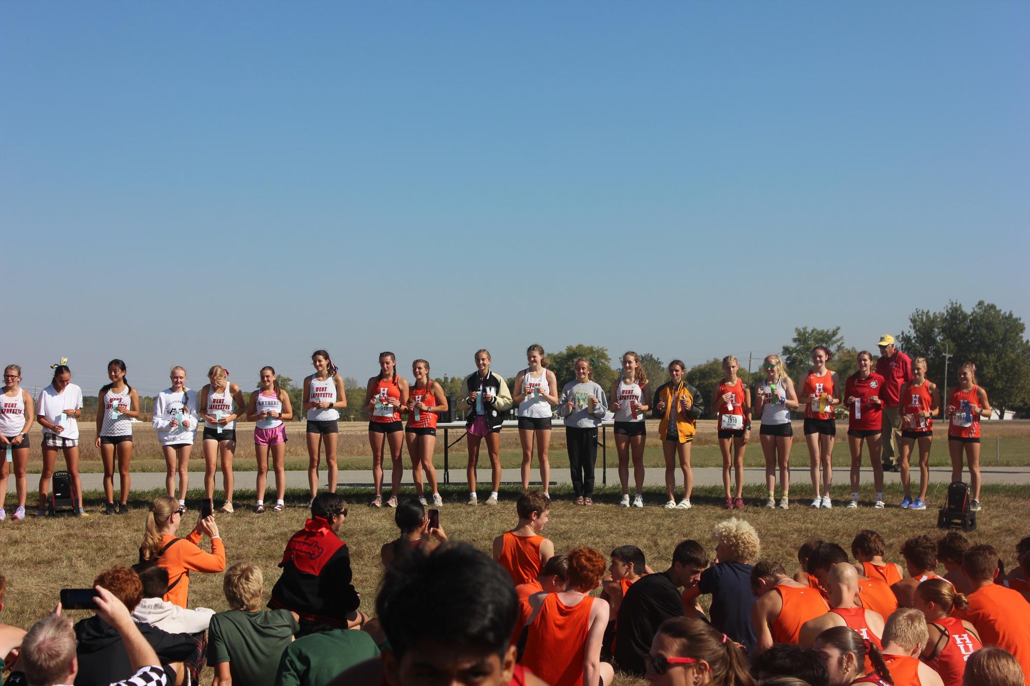 The All-Conference girls stand and pose with their ribbons and medals after all the races had finished.