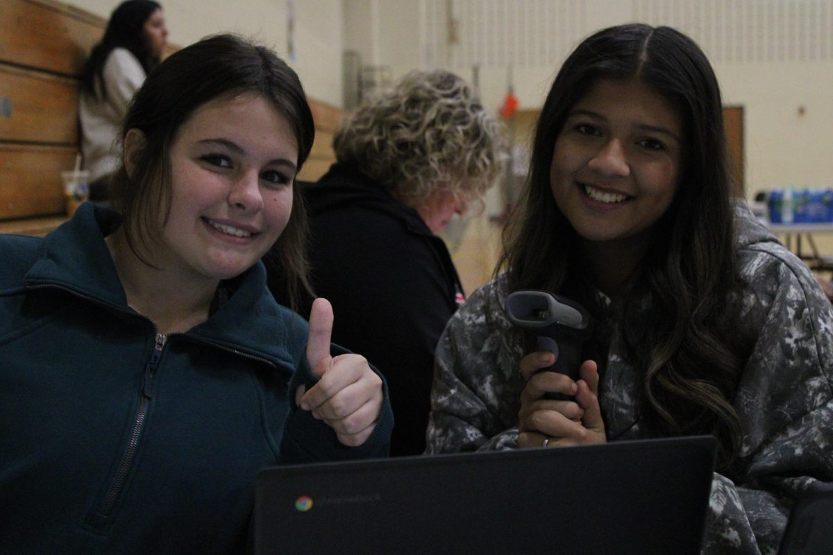 Freshman Sophia Halterman and senior Reyna Hernandez beam with excitement while greeting donors at the entrance to the blood drive.