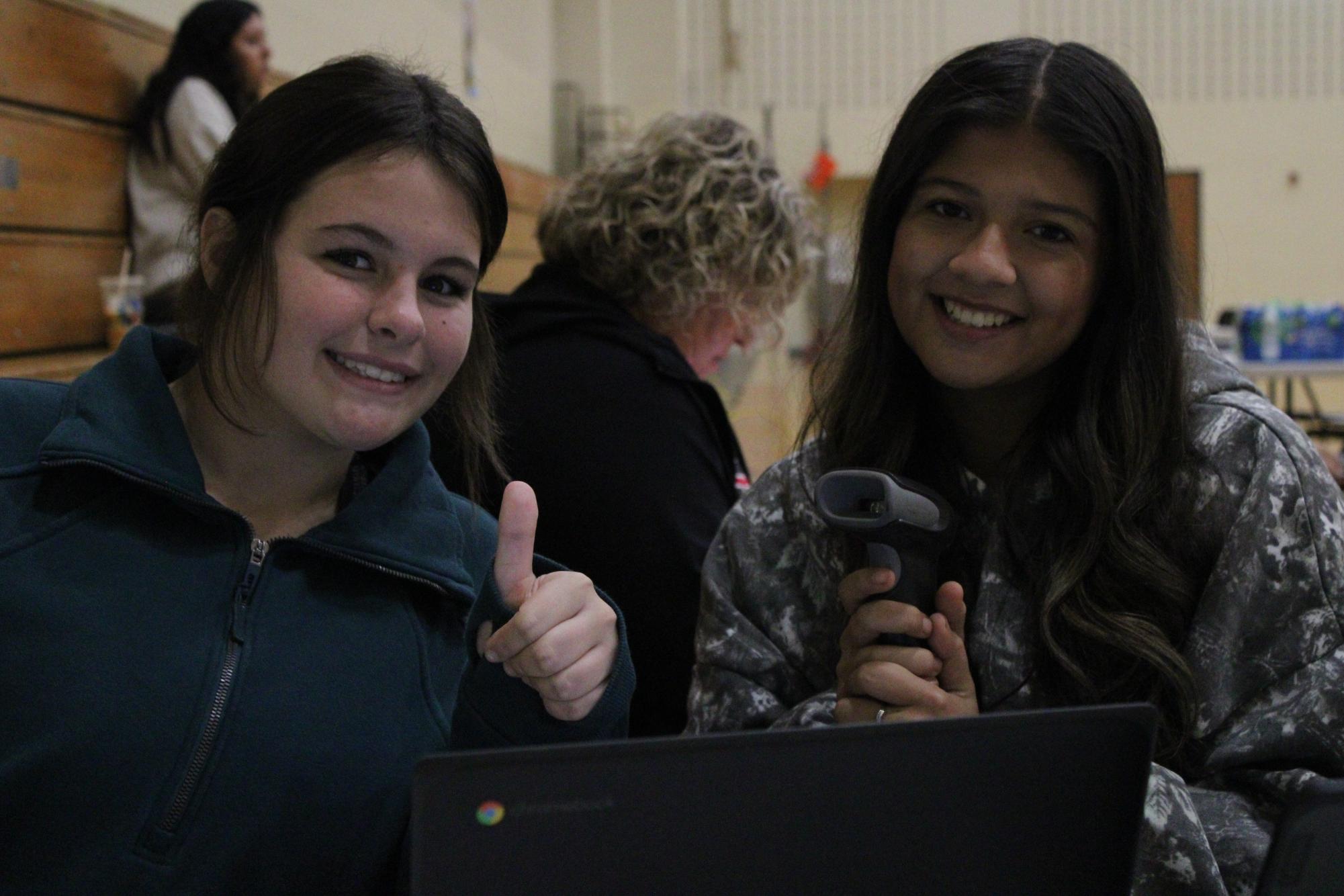 Freshman Sophia Halterman and senior Reyna Hernandez beam with excitement while greeting donors at the entrance to the blood drive.