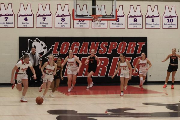 The girls varsity starting lineup rush down the court on a fast break. From left to right are sophomore Lily Clem, junior Kate Spradling, senior Goldie Kitchell, freshman Kali Messer and senior Maeda Bradbury.