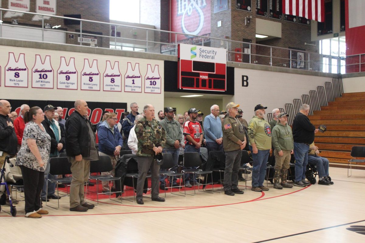 Veterans stand as the LHS band performs "Star Spangled Banner," conducted by senior Shelby Ping.