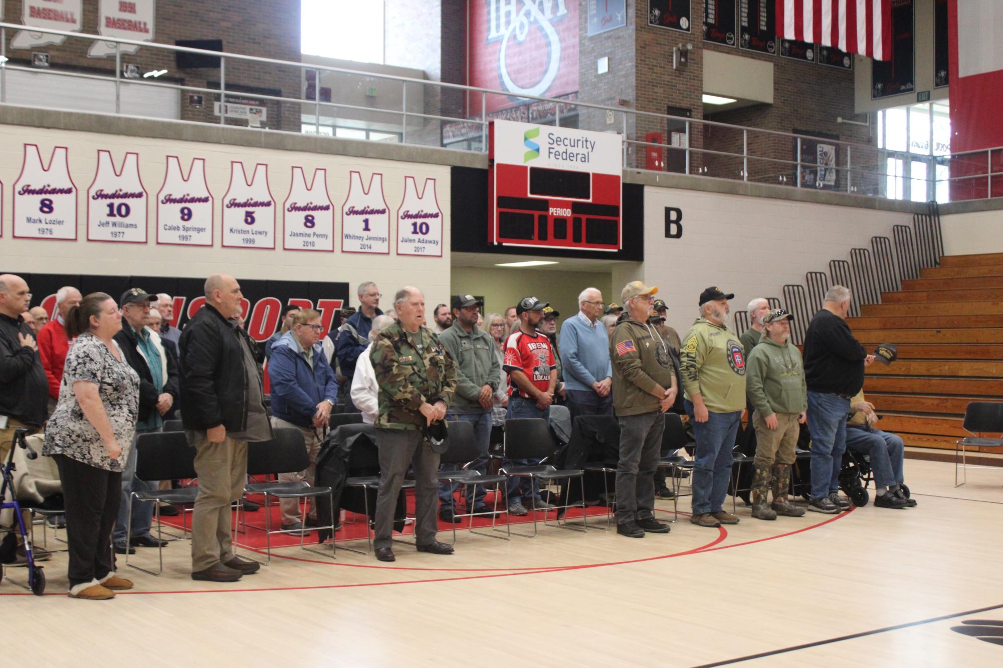 Veterans stand as the LHS band performs "Star Spangled Banner," conducted by senior Shelby Ping.