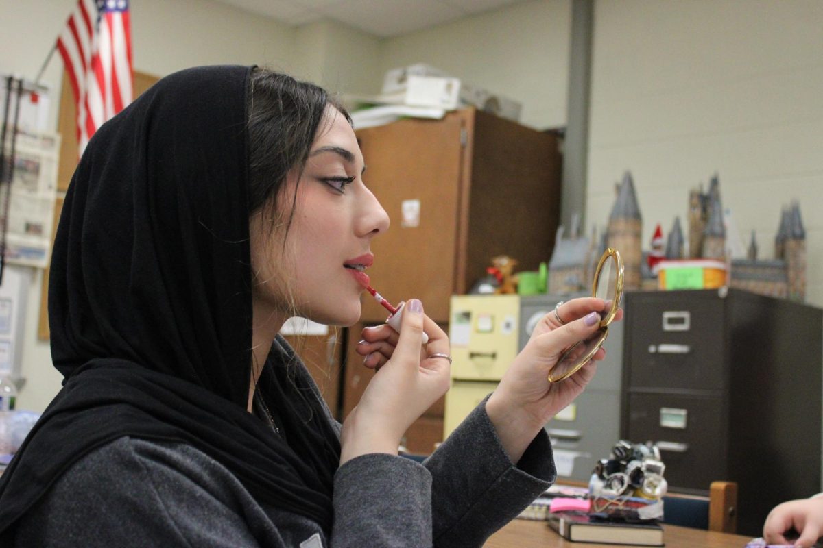 During her Journalism class, freshman Maryam Rizvi refreshes her make-up.