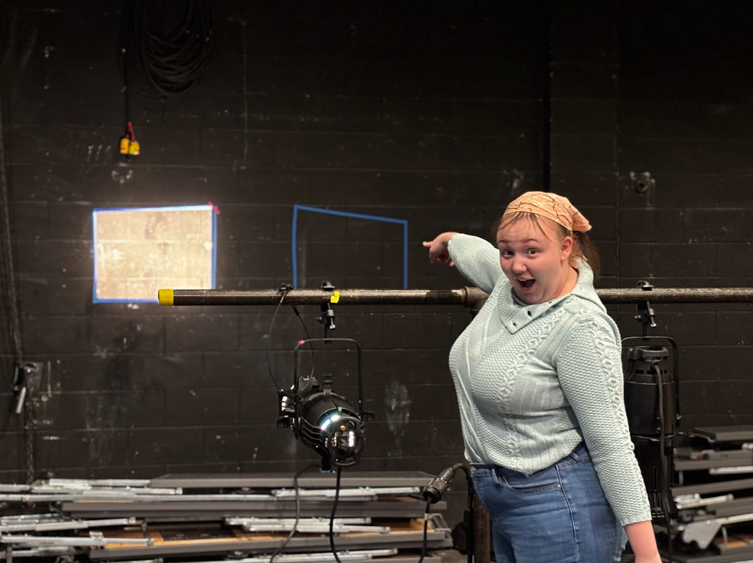 Senior Veda Fagner points enthusiastically towards the light she shaped perfectly in the lines.