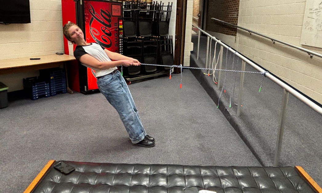 English shows how sturdy the knots are by pulling her entire body weight against them.