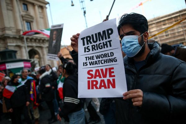 A man shows a sign mentioning U.S. President Donald Trump during a rally in support of nationwide protests in Iran, in Rome, Italy, January 13, 2026. REUTERS/Francesco Fotia
