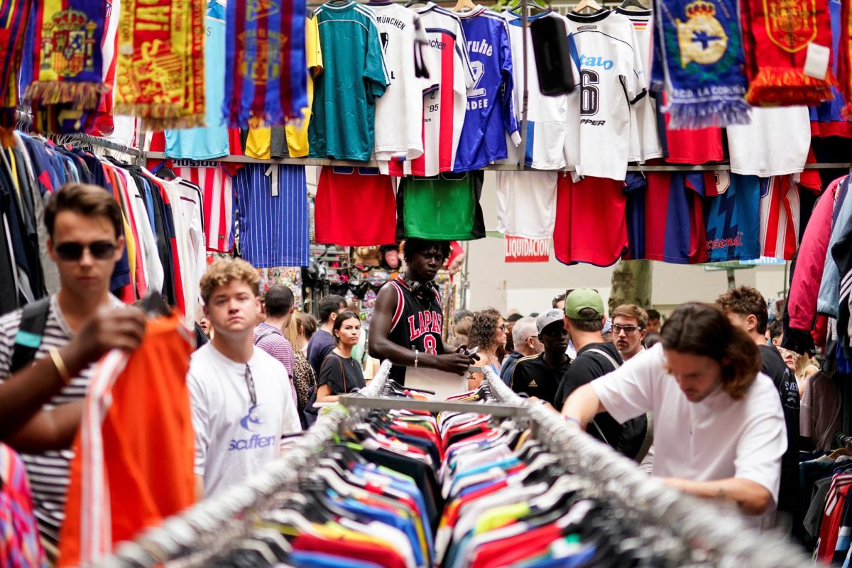 People browse clothes at a stall in El Rastro open-air market in Madrid, Spain September 7, 2025. REUTERS/Ana Beltran