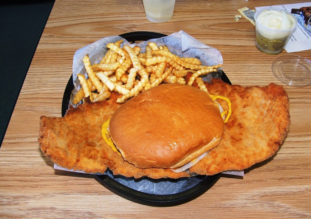 Serving a breaded pork tenderloin in a restaurant, it's a deep-fried, thin, tenderized pork, often larger than the bun.  
File:Pork tenderloin sandwich.JPG - Wikimedia Commons
