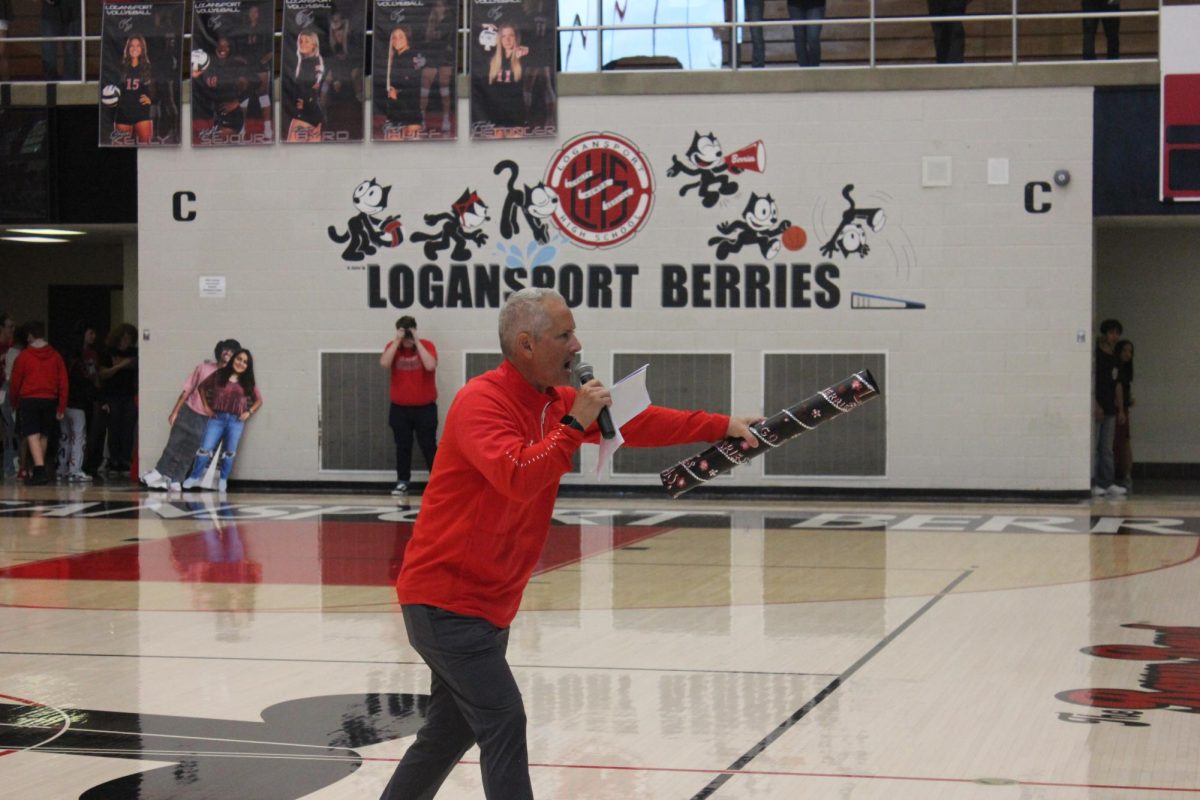 During a pep rally, former princpal Matt Jones encourages each class to cheer as loud as they can to win the spirit stick.