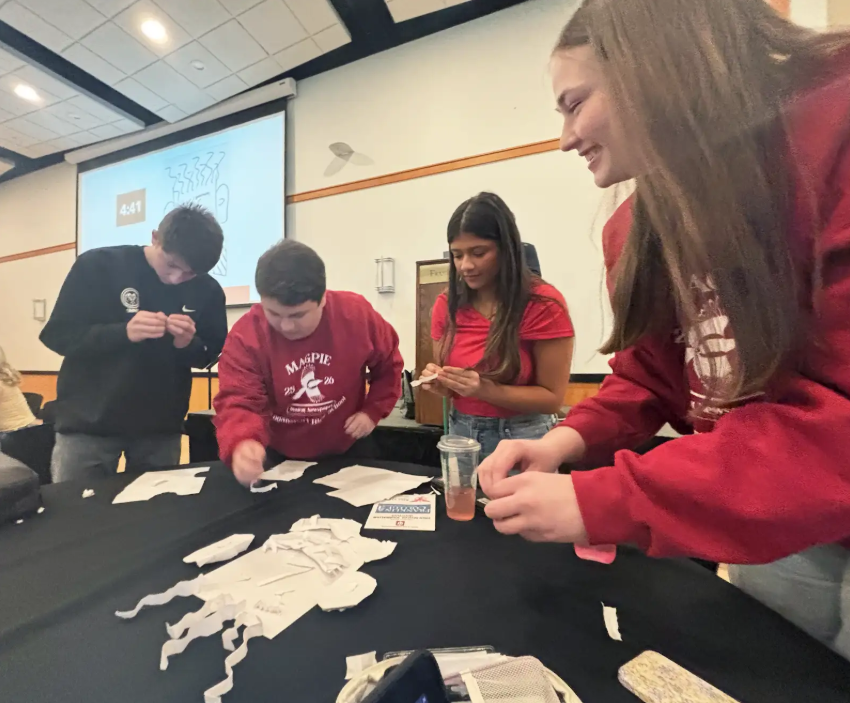 From left to right, Szmara, Lythgoe, Hernandez and Kitchell gather around a table while participating in a creative workshop.