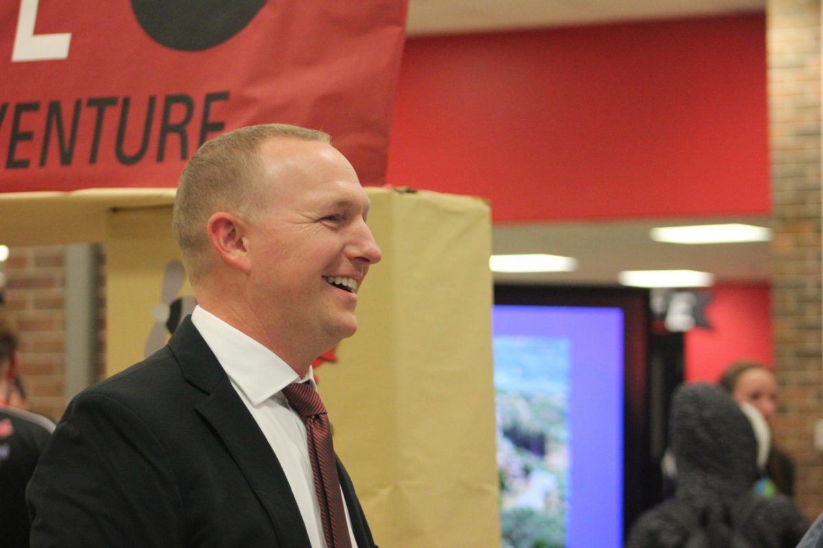 Principal Michael Miller converses with Chris Pearcy at 8th Grade Transition Night.