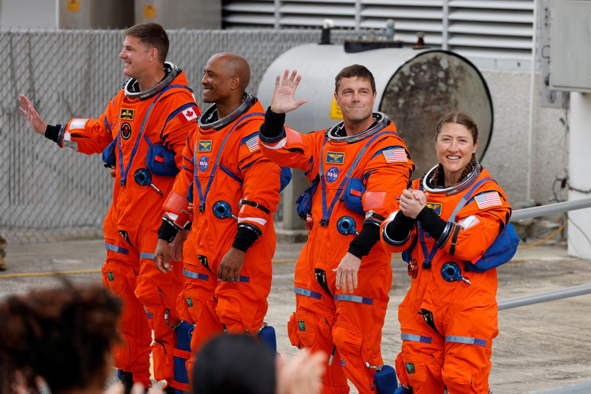 The crew of the Artemis II launch mission to fly by the moon, NASA astronauts Reid Wiseman, Victor Glover and Christina Koch and CSA (Canadian Space Agency) astronaut Jeremy Hansen greet people before boarding the astronaut van for their drive to launch pad 39B at the Kennedy Space Center in Cape Canaveral, Florida, U.S. April 1, 2026.  REUTERS/Joe Skipper