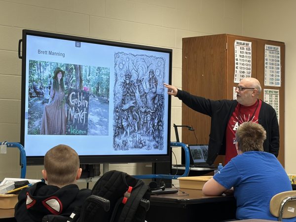 Josh Flynn discusses artists of Logansport while teaching his students about different art careers.