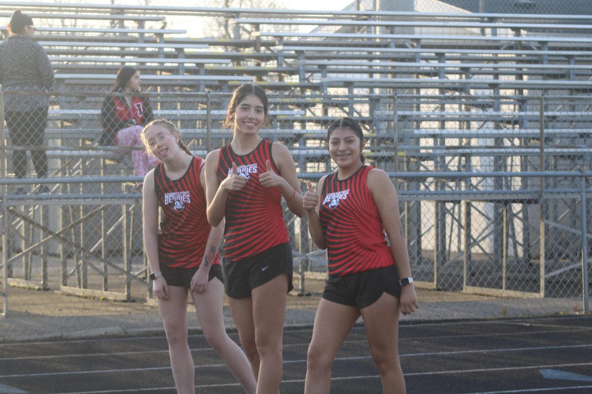Senior Nathalia Hernandez,  junior Aime Garcia, and sophomore Aubriauna DeWeese all pose for a picture before the start of their race.
