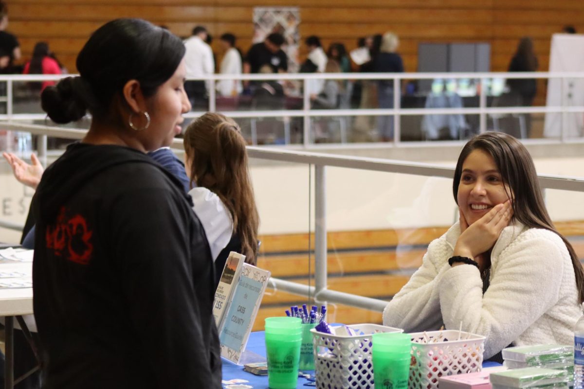 Smiling faces are always present during conversations this picture shows two young women talking about what this student wants to do with her future.